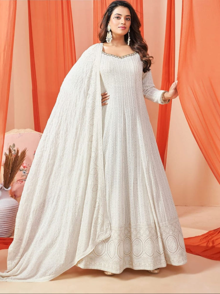 Woman in cream chikankari gown with hand embroidery all over and chikankari dupatta